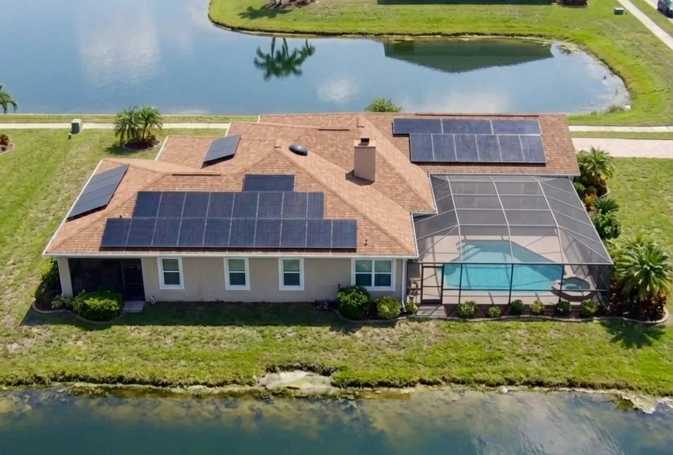 Aerial view of a rooftop solar installation on a waterfront Tampa Bay area home by May Electric Solar